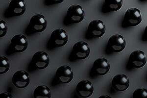 Black glossy balls arranged in a seamless pattern on a dark background. Modern, minimalist, abstract design. Concept of innovation and creativity photo