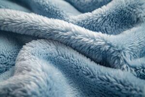 Soft blue plush fabric drapes over a surface, showcasing its texture and color in natural light photo
