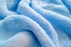 Soft blue fleece blanket draped gently on a surface showcasing its texture and color nuances photo