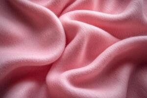 Soft, pink fabric draping elegantly across a surface, displaying smooth texture and gentle folds photo