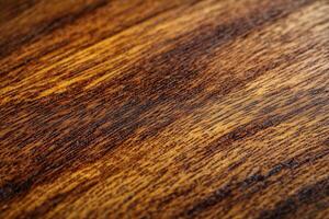 Detailed close-up of rich, textured wood grain showcasing natural patterns and colors photo