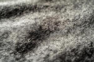 Close-up of textured gray fabric showcasing soft fibers and intricate patterns under natural light photo