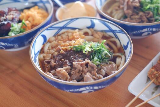 Rice noodle with beef in bowl on wooden table background. photo