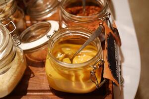 pickles in a jar on a wooden table, close-up photo