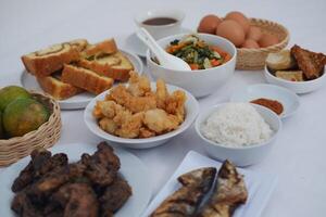 traditional Indonesian food arranged neatly on a white surface photo