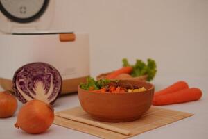 Healthy food in a wooden bowl with fresh vegetables on a tableHealthy food in a wooden bowl with fresh vegetables on a table photo
