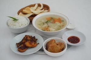 traditional Indonesian meal arranged neatly on a white surface photo
