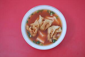 delicious red tofu soup with crackers photo