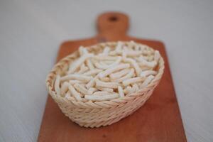 telur gabus sticks in a rattan basket on cutting board photo