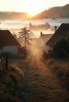 Sunrise over foggy rural village with tree silhouettes and rustic cottage photo