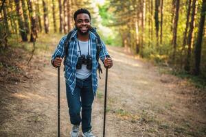 Young man enjoys hiking in nature. photo