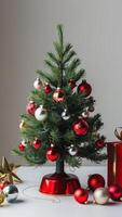 A festive Christmas tree with vibrant ornaments, set against a shimmering silver background. photo