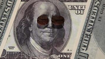 A close up of a dollar bill with sunglasses on it video