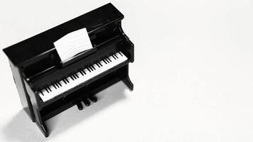 A black piano with a sheet of paper on top video