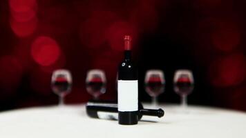 A bottle of wine and three glasses on a table video