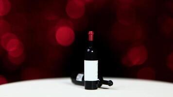 A bottle of wine on a table with red lights video