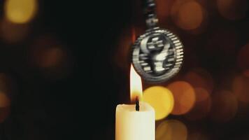 A candle with a coin hanging from it video