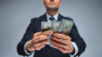 Formally dressed man is counting US Dollar bills, close-up. video