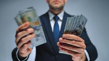 Formally dressed man is counting US Dollar bills quickly, close-up. video