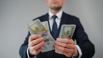 Formally dressed man is counting US Dollar bills, close-up. video