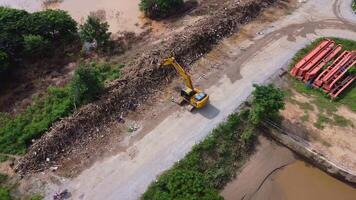 Landslides and natural disasters with excavators working on site. Natural disasters from flooding have damaged and cut off the road surface along the river. video