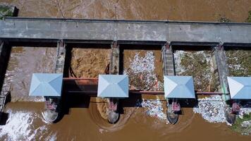 aéreo Visão do a barragem comportas com rápido fluxo do água dentro a chuvoso temporada. barragem água liberar, barragem excesso de capacidade depois de pesado chuva. video