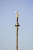 Telecommunication tower. Mobile phone tower with 5G cellular network . Global connection and internet network concept. City satellite tower. photo