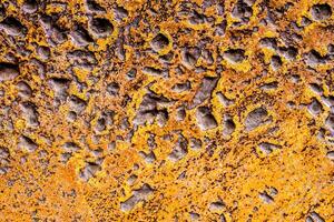 Rugged holes on the rusty color concrete floor photo