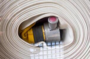 Roll of canvas hose in the emergency firefighting box photo