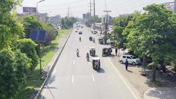 traffic is moving on road and a lot of tree showing healthy environment in Lahore on September 07, 2024. video
