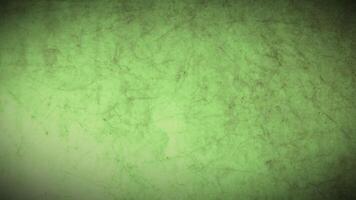 A green grunge texture background with a light video