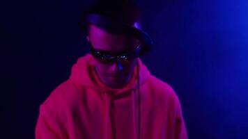 Energetic DJ performance at a vibrant night party in a colorful club setting video