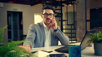 Professional man working intently in a modern office setting during the day video