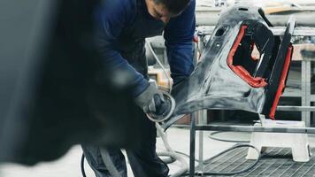 Skilled worker shaping automotive parts in a workshop focusing on precision and craftsmanship video
