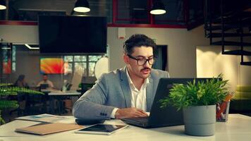 Focused work in a modern office space with plants, during a busy afternoon in a collaborative environment video