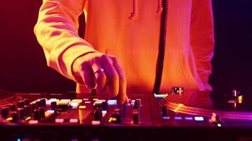 A DJ mixes vibrant tracks with colorful lights at a local club for an electrifying night of music and dance video