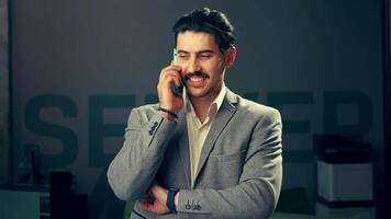 Business professional speaking on the phone in a modern office setting during the afternoon hours video