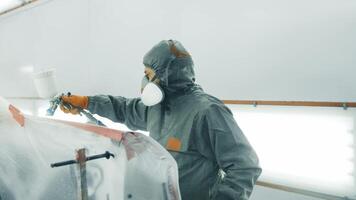 Professional automotive paint application at a workshop in the early morning video