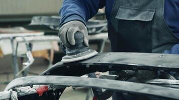 Car restoration process in a workshop with sanding and refinishing techniques demonstrated video