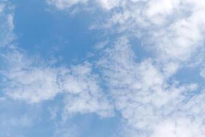 Blue sky with fluffy white clouds on a sunny summer day. Soft fluffy clouds in the blue sky photo