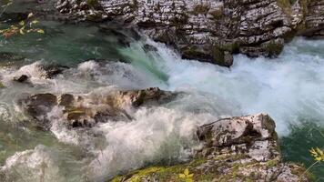 Dramatic canyon scenery. a cascading river flows through a narrow gorge with sunlight and shadows. video