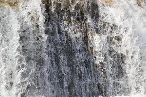 Pouring a beautiful waterfall in the moment with the visible suspended water particles photo