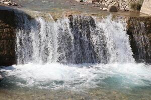Pouring a beautiful waterfall in the moment with the visible suspended water particles photo