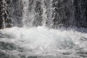 Pouring a beautiful waterfall in the moment with the visible suspended water particles photo