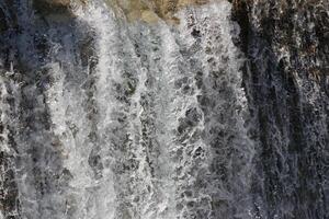 Pouring a beautiful waterfall in the moment with the visible suspended water particles photo