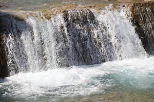 Pouring a beautiful waterfall in the moment with the visible suspended water particles photo