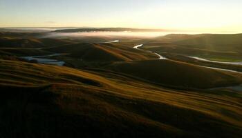 Aerial View of Serene Rolling Hills at Sunrise with Golden Light, Misty Valleys, Grassy Meadows, and Winding Rivers in Untouched Countryside. video