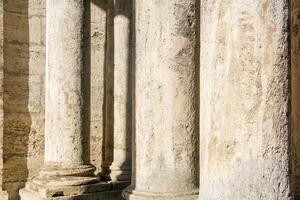 abstract architectural background - columns and walls made of light stone photo