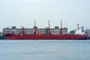 bulk carrier ship in a cargo port on a cloudy day photo