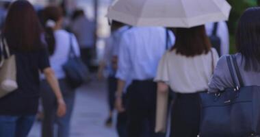 A slow motion of walking office worker at the business town in Tokyo telephoto shot video